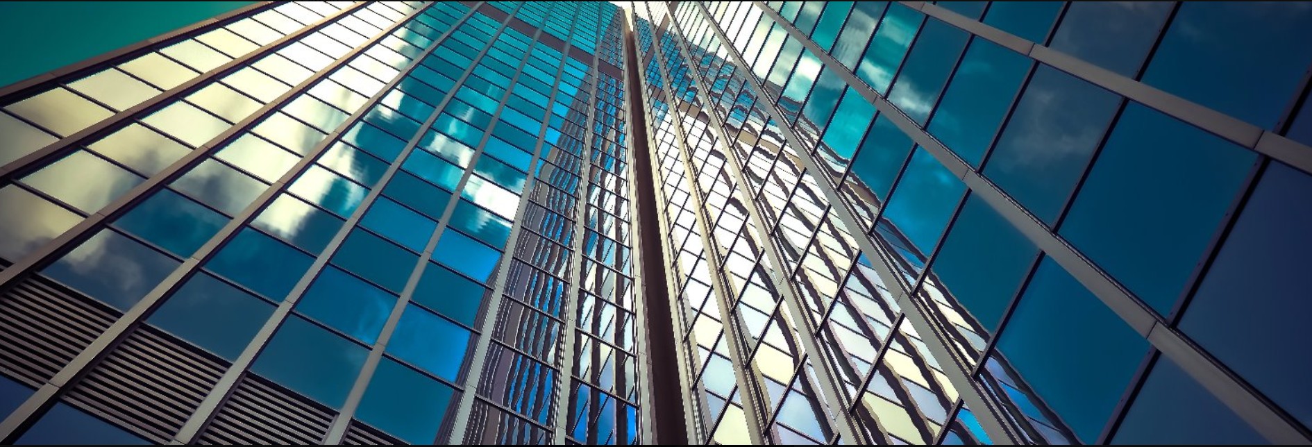 Glass architecture rising into the blue sky